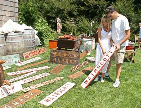 Lauri Fliegel and Steven Merdinger settle on a sign at the East Hampton Historical society's Antiques at Mulford Farm show on Saturday.