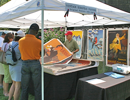 Art Finkel with vintage posters at the Antiques at Mulford Farm show hosted by the East Hampton Historical Society on Saturday.