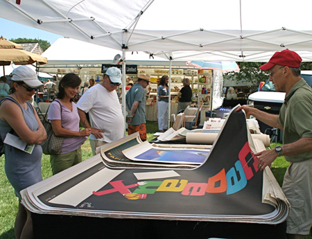 Art Finkel with vintage posters at the Antiques at Mulford Farm show hosted by the East Hampton Historical Society on Saturday.