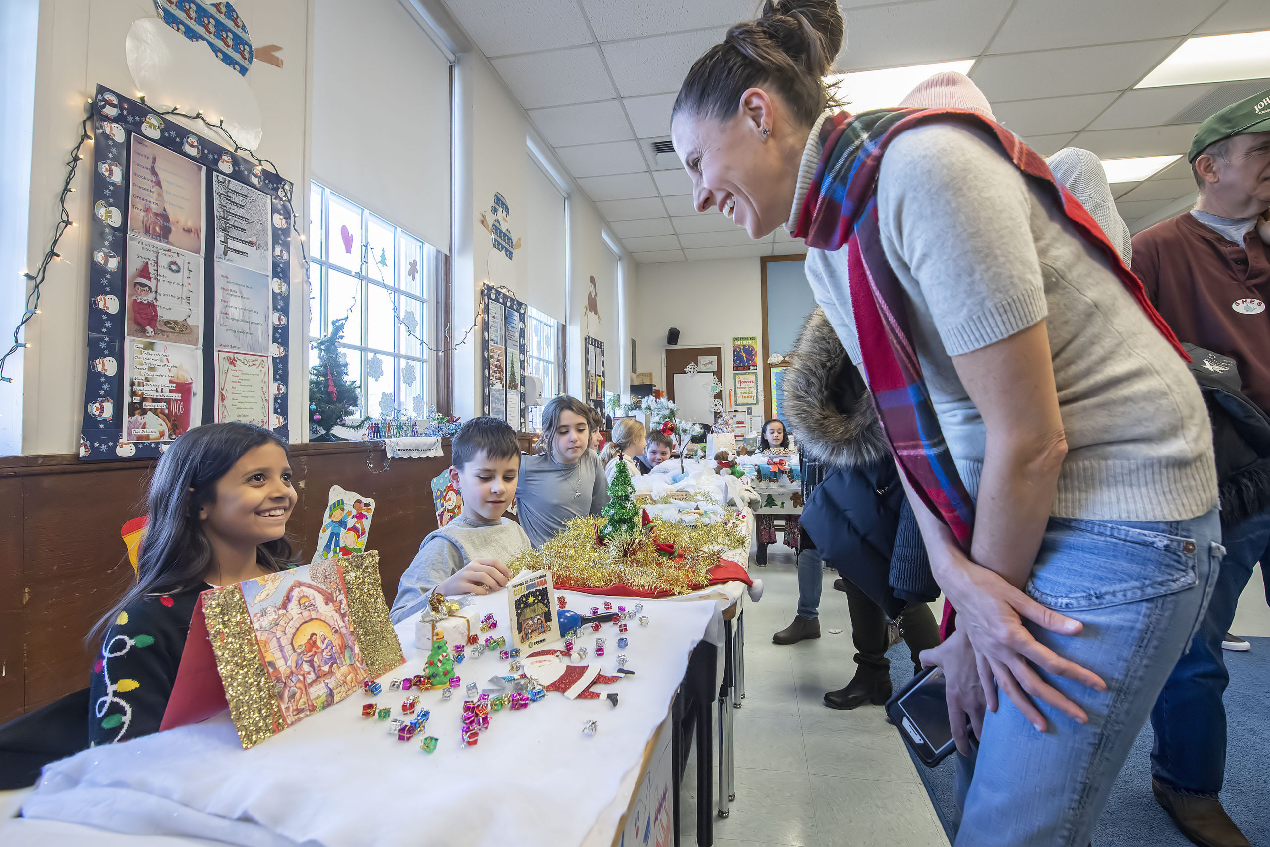Erin Yaeger checks out Alexis Salazar's display depicting Baby Jesus during the annual Winter Museum Showcase event held by 4th Graders at the Sag Harbor Elementary School on Thursday morning.    MICHAEL HELLER