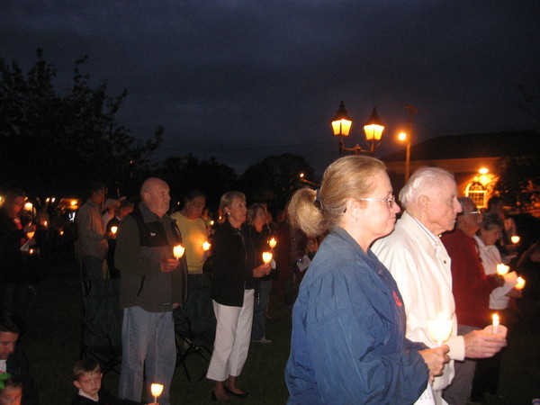  and Ryan Campbell of Boy Scout Troop 62 of Westhampton Beach pay respect at a memorial service held Sunday night on the village green. LISA FINN