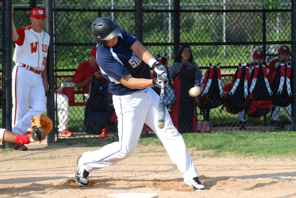 ESM senior Sean Doyle drives the ball to right field for a sacrifice fly.     DREW BUDD