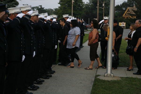 Firefighers from New York City Ladder 104 and Engine 221 gathered at Sinnickson's Funeral Home in Center Moriches on Monday to pay tribute to veteran firefighter Paul Warhola.