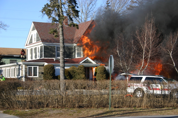 Flames engulf a home on the corner of Fanning and Ponquogue avenues in Hampton Bays on Thursday afternoon.     FRANK S. COSTANZA
