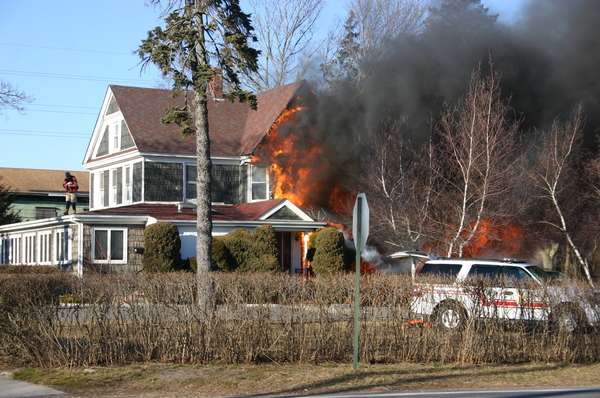 Flames engulf a home on the corner of Fanning and Ponquogue Avenues on Thursday afternoon.   FRANK S. COSTANZA
