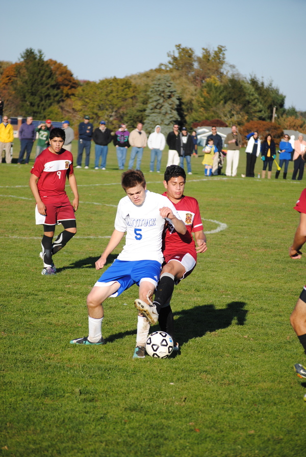 Mariner freshman Elliott LaGuardia fends off a Mattituck defender.