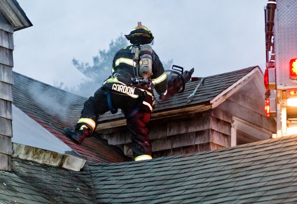 Firefighters from three departments work to put out a fire at 33 Quantuck Bay Lane on Quiogue on Saturday night. COURTESY WESTHAMPTON BEACH FIRE DEPARTMENT