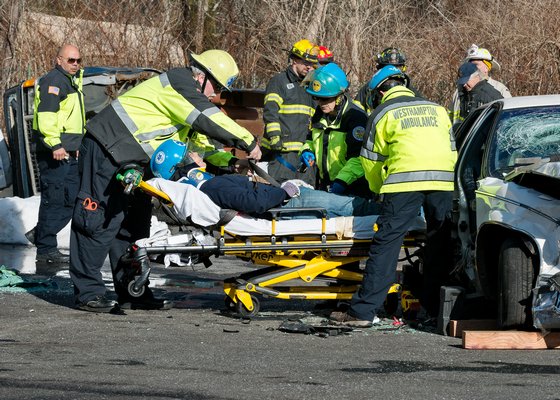 Volunteers with the Westhampton War Memorial Ambulance ready their “victim” for transport during Sunday's simulation. COURTESY WESTHAMPTON BEACH FIRE DEPARTMENT