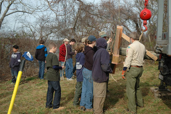 Scouts help attach the osprey platform to the pole.