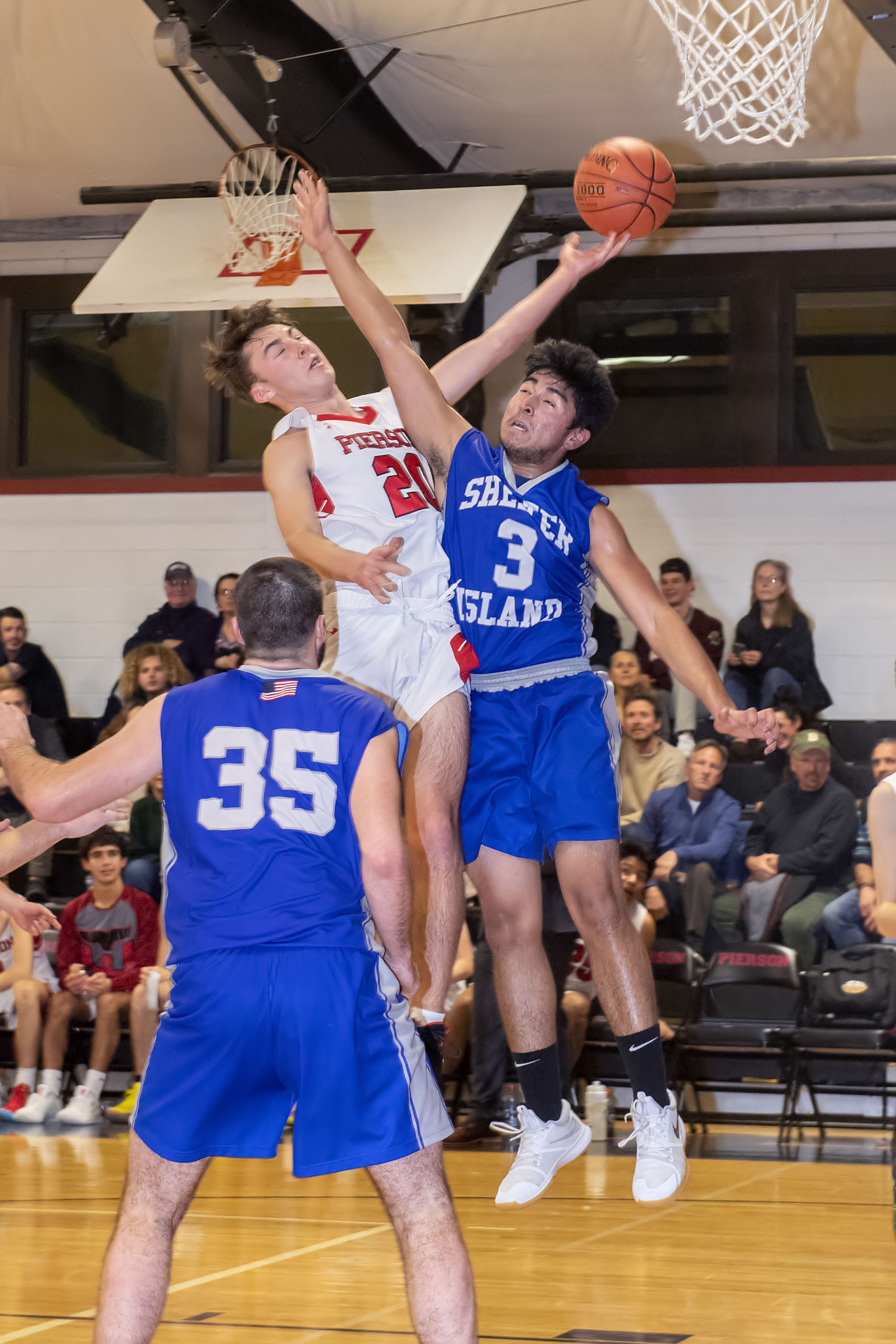 Whaler Pierce Summers clashes with a Shelter Island defender.