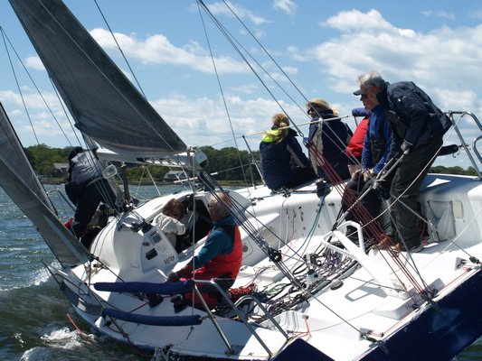 Sailors of Purple Haze maneauver their boat during the regatta. SARAH WARREN