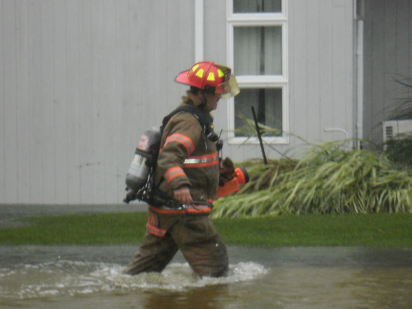 A member of The Westhampton Beach Fire Department wades through flood waters caused by Hurricane Irene. COURTESY WHB FIRE DEPARTMENT