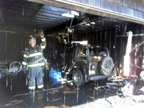 Members of The Westhampton Beach Fire Department  put out a fire after  Hurricane Irene. COURTESY WHB FIRE DEPARTMENT