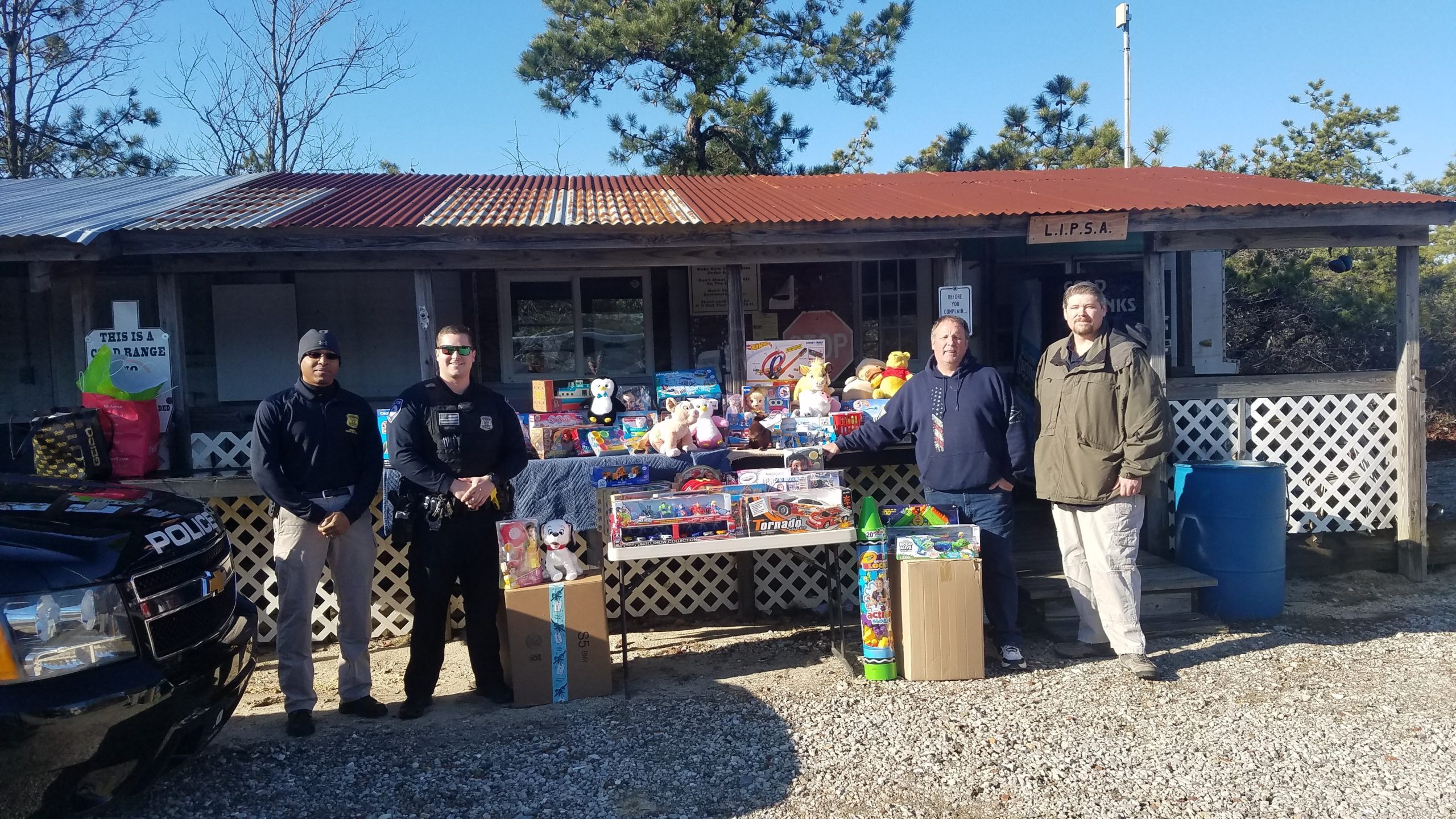 Westhampton Beach Police Benevolent Association President Detective Brian Prescott, Secretary Officer Andrew Kirwin, Vice President of Long Island Practical Shooters Association James Byrne and member of LIPSA Nicholas Schillaci gathering toys to donate for the holidays.