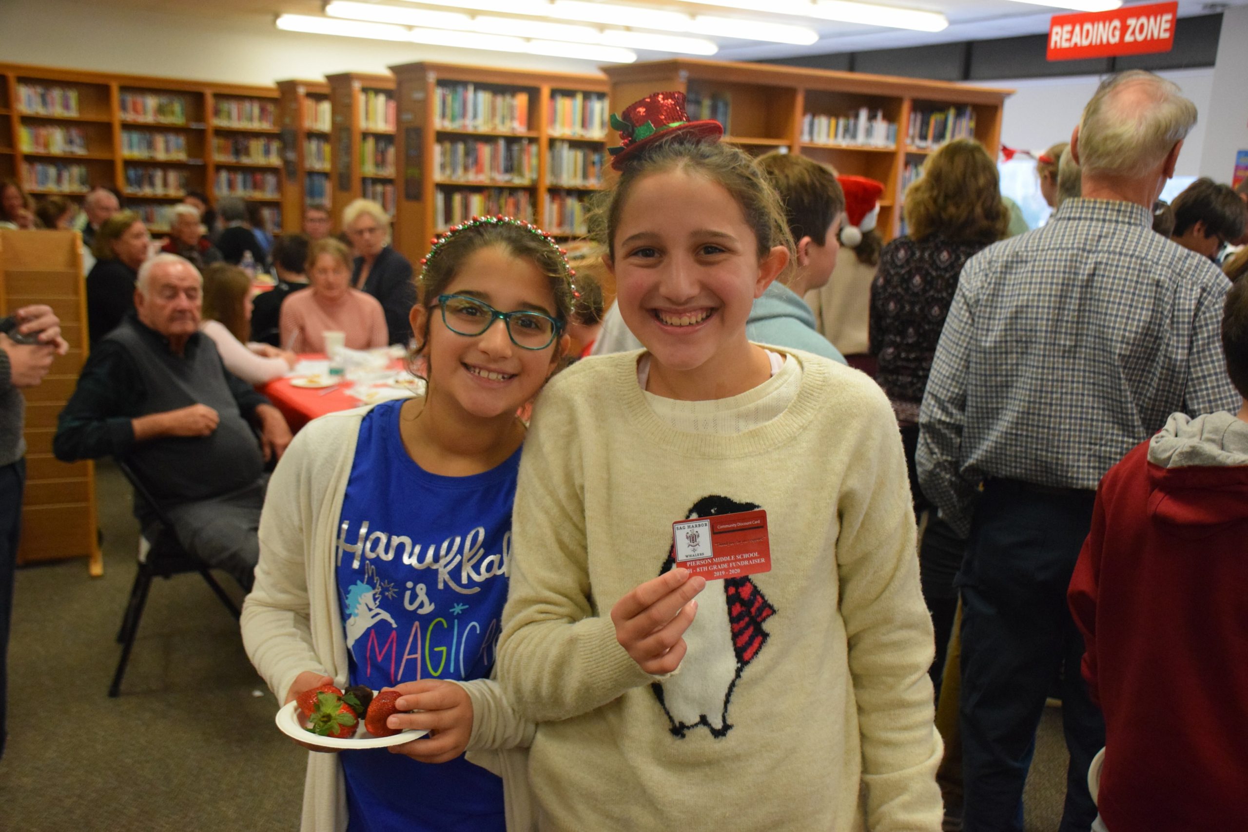 Pierson Middle School hosted its annual Snowflake Tea on December 13. At the annual event, students in grades six, seven and eight gathered with their grandparents and role models to share schoolwork and projects and kicked off the season with a holiday singalong. Lily and Isabelle Caplin visited local businesses to get their support for the school trip “rewards card.”
