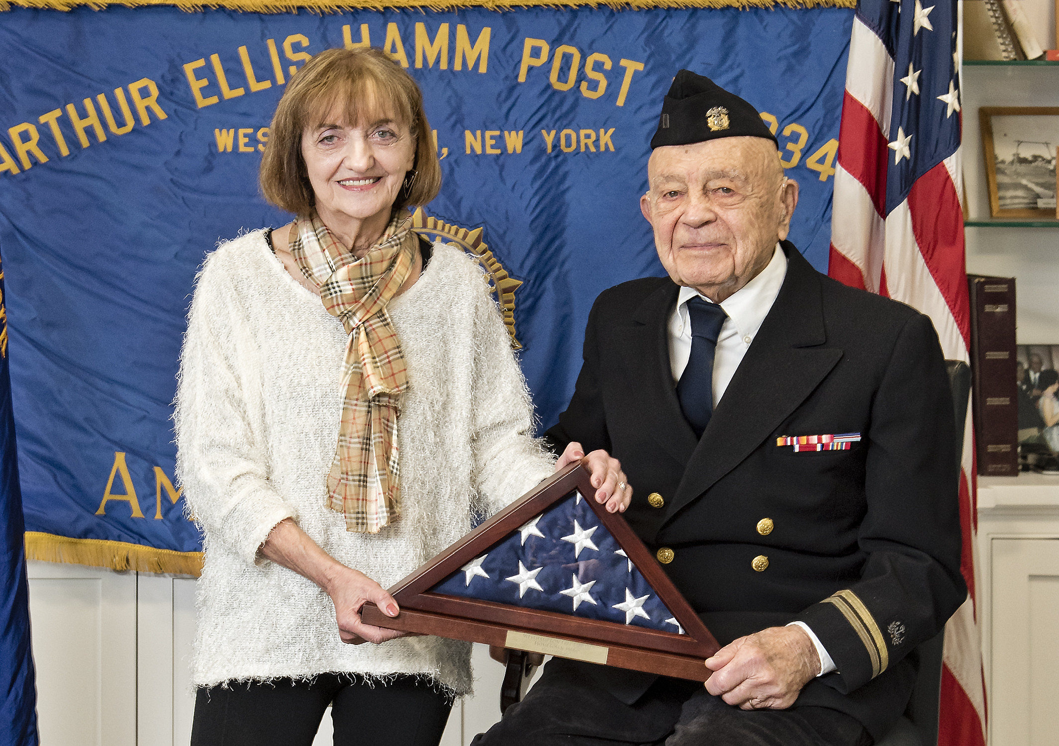 The Westhampton Free Library and Post 834 of the American Legion honored Michael Pope of Remsenburg as one of its Hometown Heroes this Saturday for his service in the Merchant Marine during World War II. Library trustee Maryanne Yutes presented Mr. Pope with a flag that had flown over the library. Courtesy Westhampton Beach Fire Department 