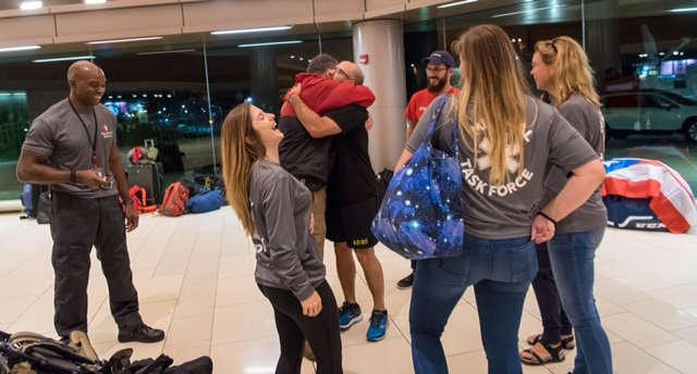 It was all hugs and smiles as Stony Brook Medicine volunteers gathered in the hospital lobby before the early morning departure for the flight to Puerto Rico. COURTESY STONY BROOK UNIVERSITY