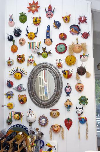 On the wall that separates the kitchen is a fun display of several dozen Mexican coconut masks adorned with flowers