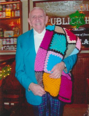 Raymond Tureski holds the afghan blanket made for him by the Ladies Auxiliary VFW of Southampton.