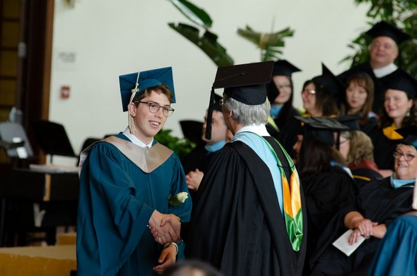 Christian M. '18 receives his diploma from Ross School Head of High School Bill O'Hearn.    COURTESY ROSS SCHOOL