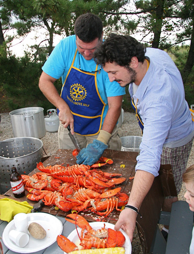  Noti Krasniqi and Jackson Baris with the lobseter at the East Hampton Rotary Club's annual lobster cookout at Clearwater Beach in Springs on Monday.
