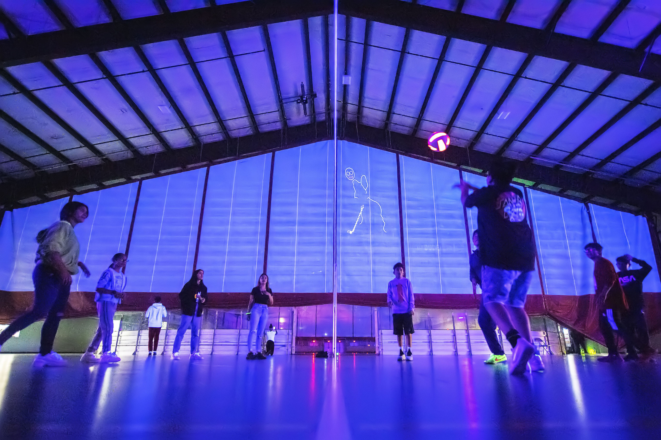 Kids play volleyball during the Lights Out! Glow Night event at the SYS facility in Southampton on Friday night. MICHAEL HELLER