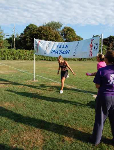 Participant Charlotte Detwiler prepares to start the second leg of the triathlon. Detwiler raised $2