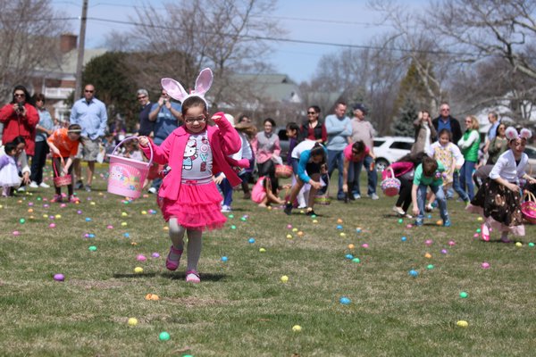 Children in the 7 year old and up age groups scramble to find eggs at the Greater Westhampton Chamber of Commerce’s 18th annual Egg Hunt to begin on the Great Lawn on Saturday