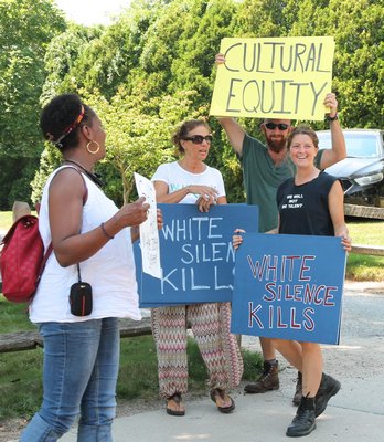 Members of the Black Lives Matter rally chanting and holding signs in front of Herrick Park on Sunday JON WINKLER
