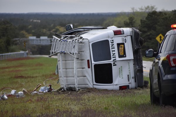 A painting company van rolled onto its driver's side on the westbound median of Sunrise Highway between exit 64N and exit 64S on Monday afternoon. BRENDAN J. O'REILLY