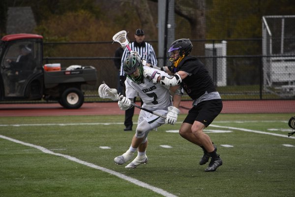 Westhampton Beach senior Chris Merle takes a stick to the neck but manages to fight through it. DREW BUDD