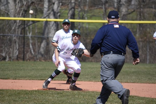 Westhampton Beach senior Matt Pesce takes a throw from junior catcher Thatcher Cord to catch a Sayville baserunner trying to steal second base. DREW BUDD