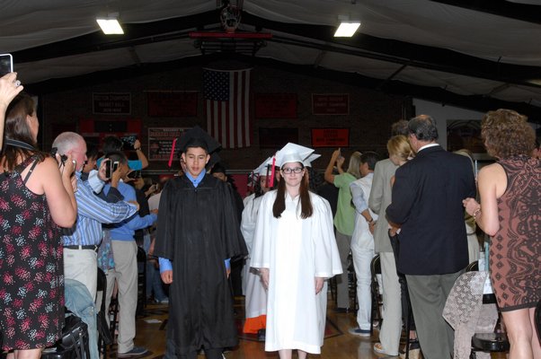 Graduates  at Pierson enter the gym at the beginning of commencement on Saturday evening.