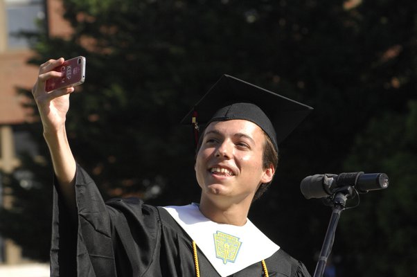 Valedictorian Cole Severance takes a selfie with his class during his commencement speech.