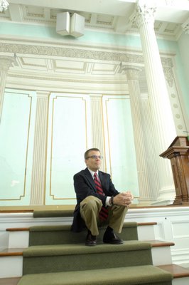 The Rev. Mark Phillips in front of the  trompe l'oeil at the Old Whalers' Church in Sag Harbor