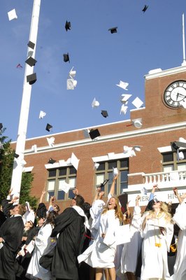 The graduates toss thier mortar boards.