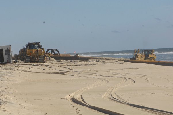 Finishing touches were put on the dredge pipe just east of Scott Comeron Beach on Monday. DANA SHAW