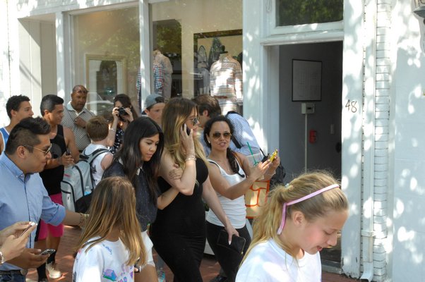 Kourtney and Khloe Kardashian pose with fans outside of Intemix on Main Street in Southampton Village on Tuesday afternoon.  DANA SHAW
