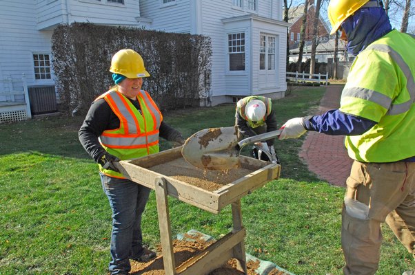 Archaeological Field Technicians Sara Regensburger and Douglas Boucher of the Louis Berger Group dig and sift through soil at the Rogers Mansion on Wednesday.  DANA SHAW