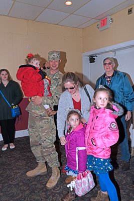  Nicholle and holds his daughter Adeline at a surprise homecoming celebration at the American Legion Hand-Aldrich Post 924 in Hampton Bays on Tuesday afternoon. DANA SHAW
