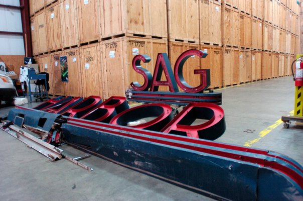  owner of Twin Forks Moving & Storage at the facility in Bridgehampton with the Sag Harbor Cinema sign.  DANA SHAW