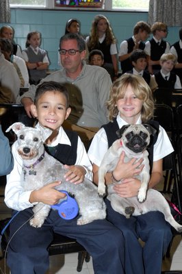 Fifth grade students fifth graders Justin Jiminez and Derek Elasik with their perts at the blessing of the animals at OLH.