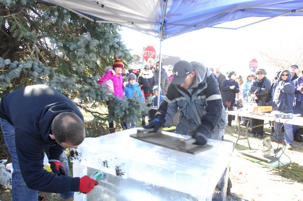 Work on the ice sculpture at Long Wharf on Saturday.