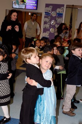 Natalie Glanz and Tanner Tietjen share a hug at the Pre-K Snow Ball on Thursday.