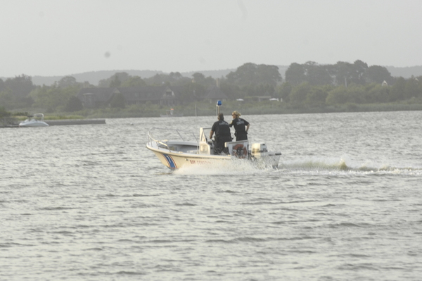 Emergency crews search for a missing jet skier in Mecox Bay on Sunday evening.  DANA SHAW