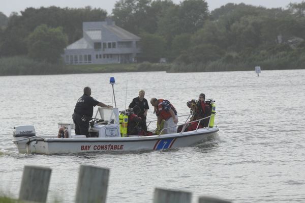 Emergency crews search for a missing jet skier in Mecox Bay on Sunday evening.  DANA SHAW