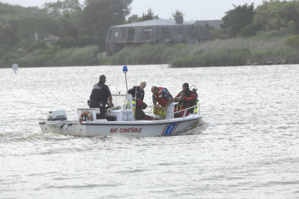 Emergency crews search for a missing jet skier in Mecox Bay on Sunday ev