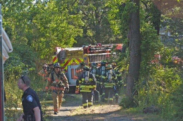 Firefighters respond to a structure fire on Flying Point Road on Monday afternoon.  DANA SHAW