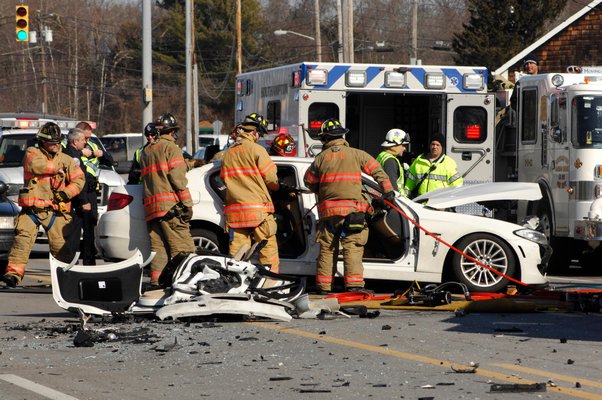 The Southampton Fire Department work to extricate the drive of the accident on County Road 39 this afternoon.  DANA SHAW
