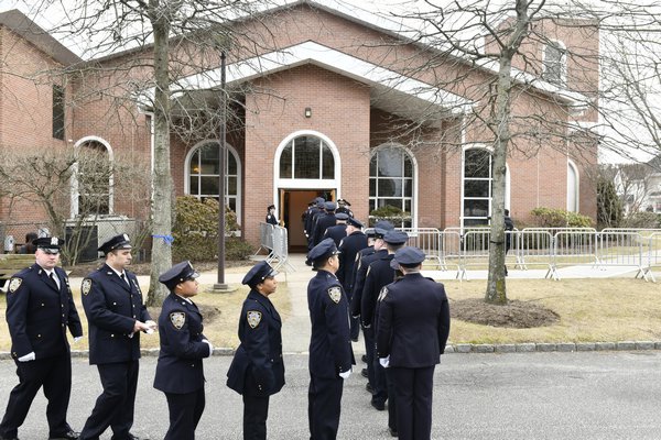 Officers enter St. Rosalie's Church in Hampton Bays Wednesday morning. DANA SHAW